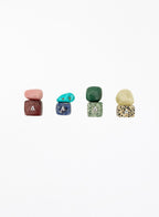 multicoloured crystal stones set in white background