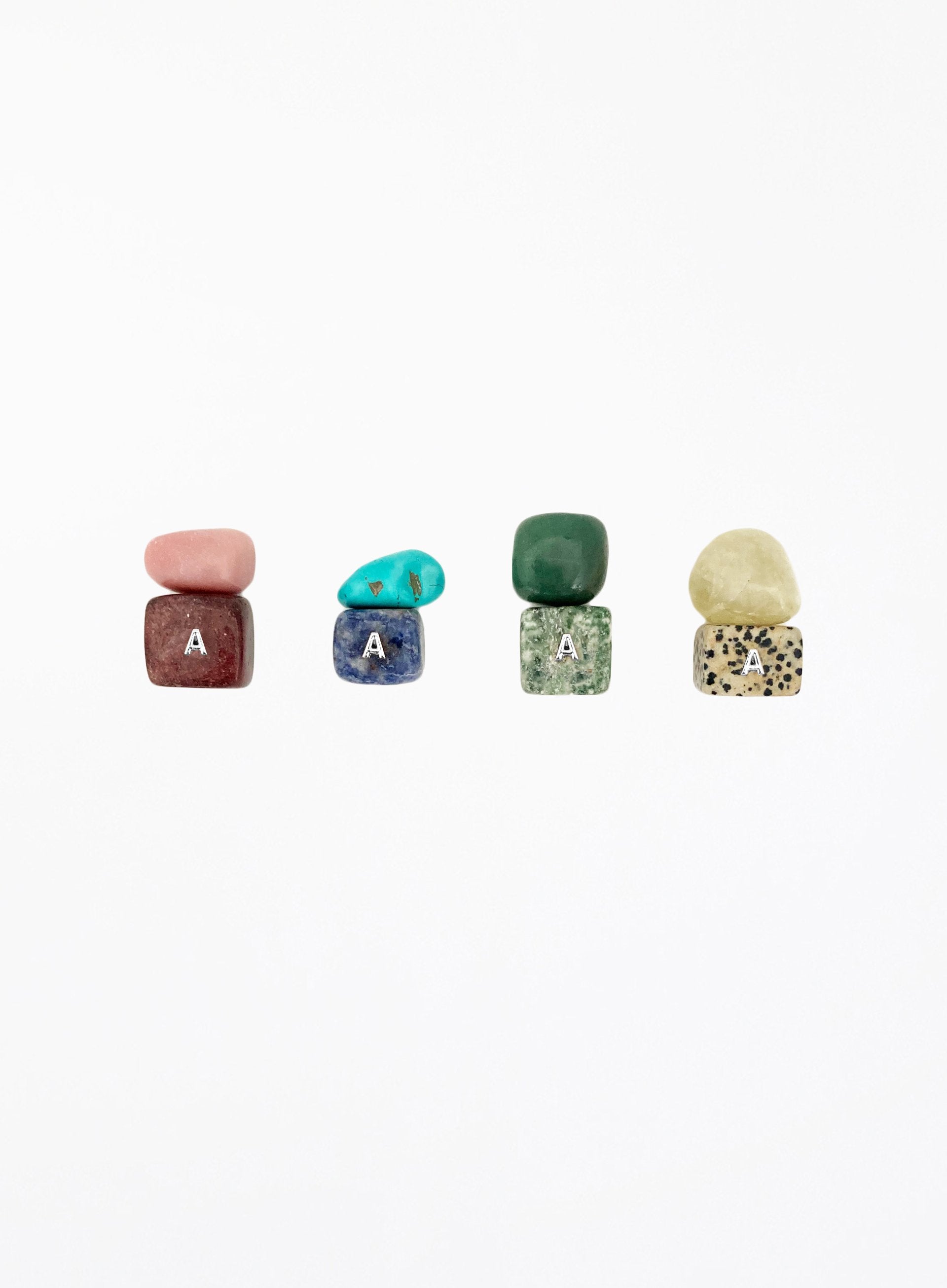 multicoloured crystal stones set in white background