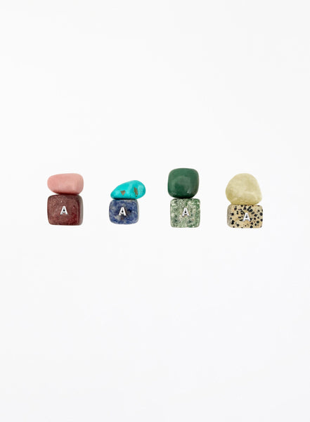 multicoloured crystal stones set in white background