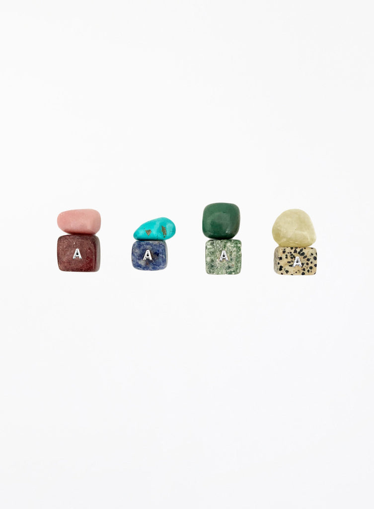 multicoloured crystal stones set in white background