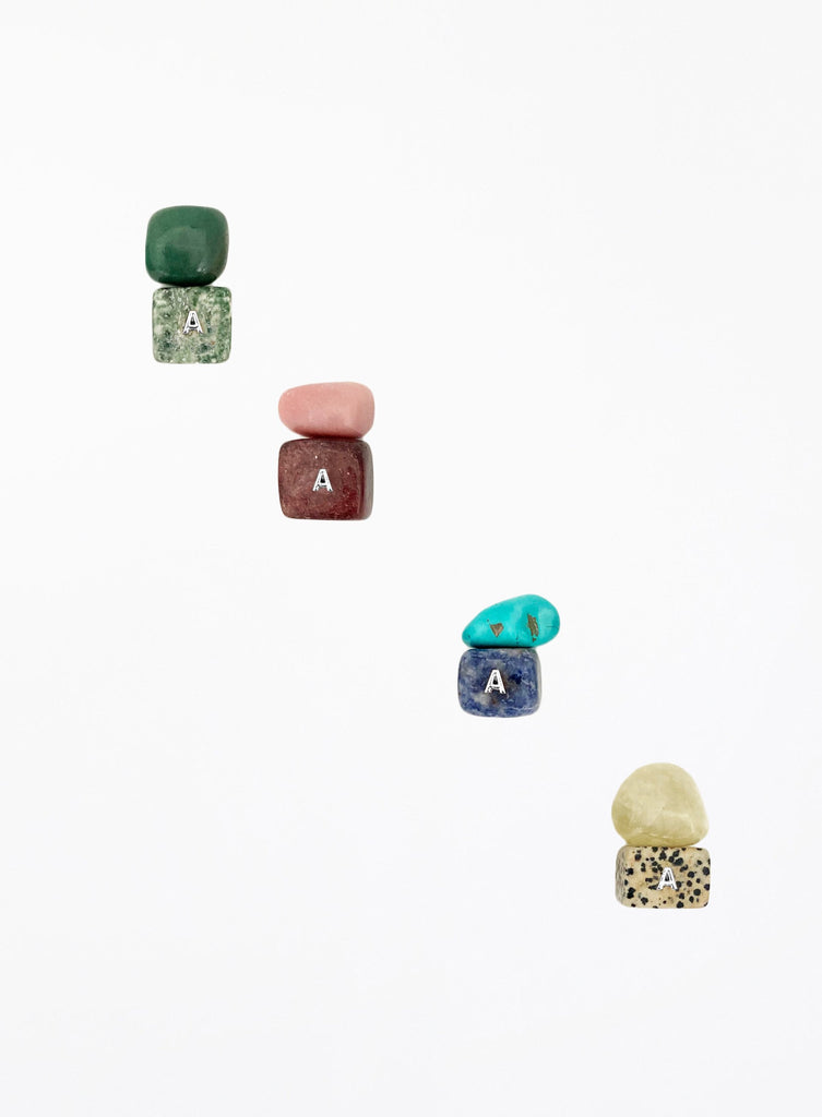 multicoloured crystal stones set in white background