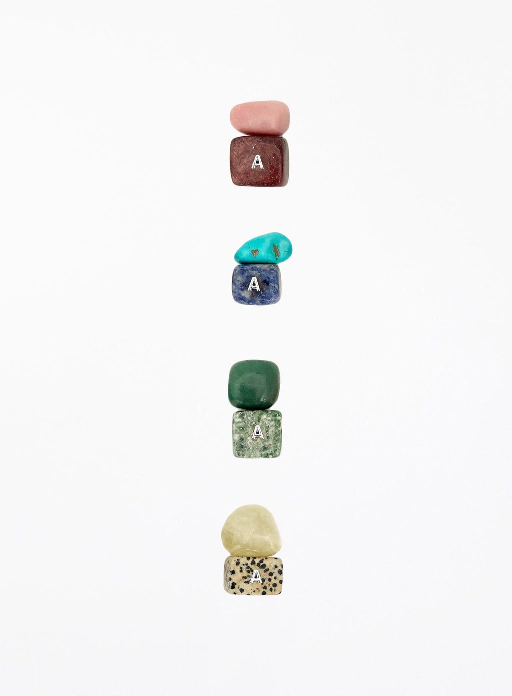multicoloured crystal stones set in white background
