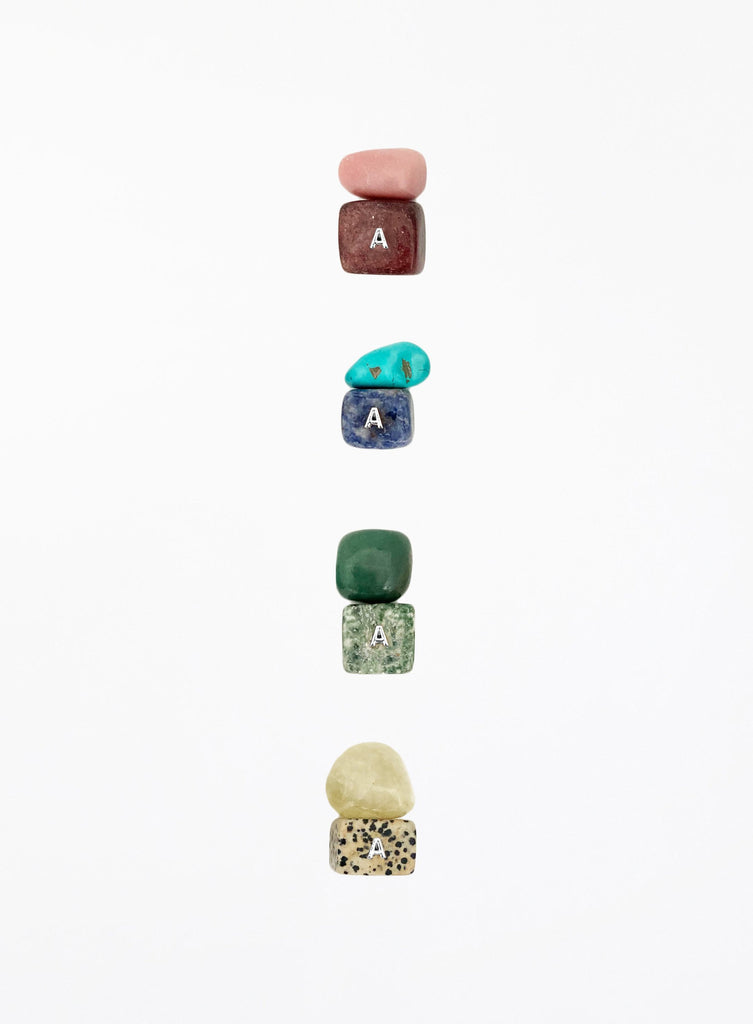 multicoloured crystal stones set in white background