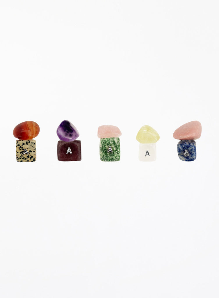 Set of colorful stone-shaped letter 'A' charms on a white background