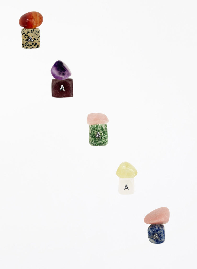 Set of colorful stone-shaped letter 'A' charms on a white background