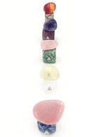 Set of colorful stone-shaped letter 'A' charms on a white background
