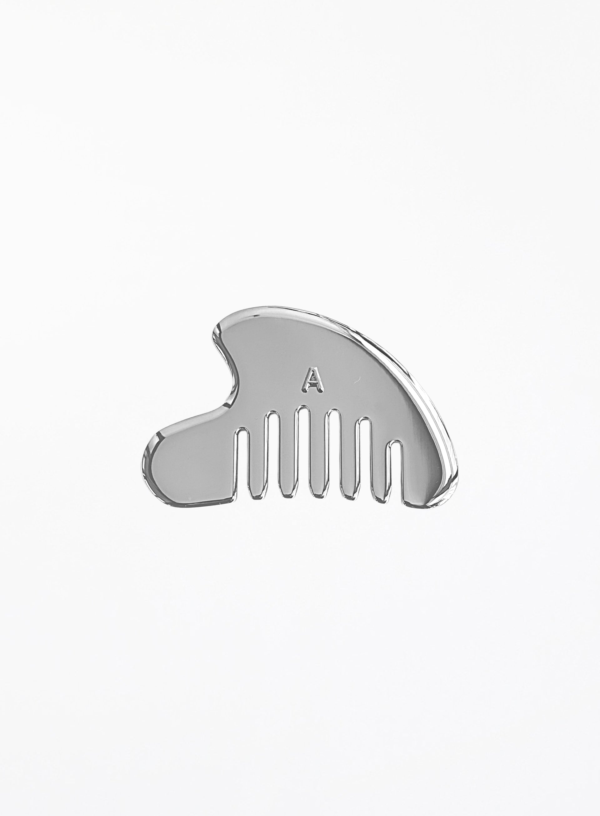 A polished silver metal hair comb with a small engraved letter 'A' on the front, shown against a plain white background.
