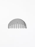 A silver metal hair comb with a semi-circular back and a small engraved letter 'A' in the center, shown on a plain white background.