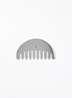 A silver metal hair comb with a semi-circular back and a small engraved letter 'A' in the center, shown on a plain white background.