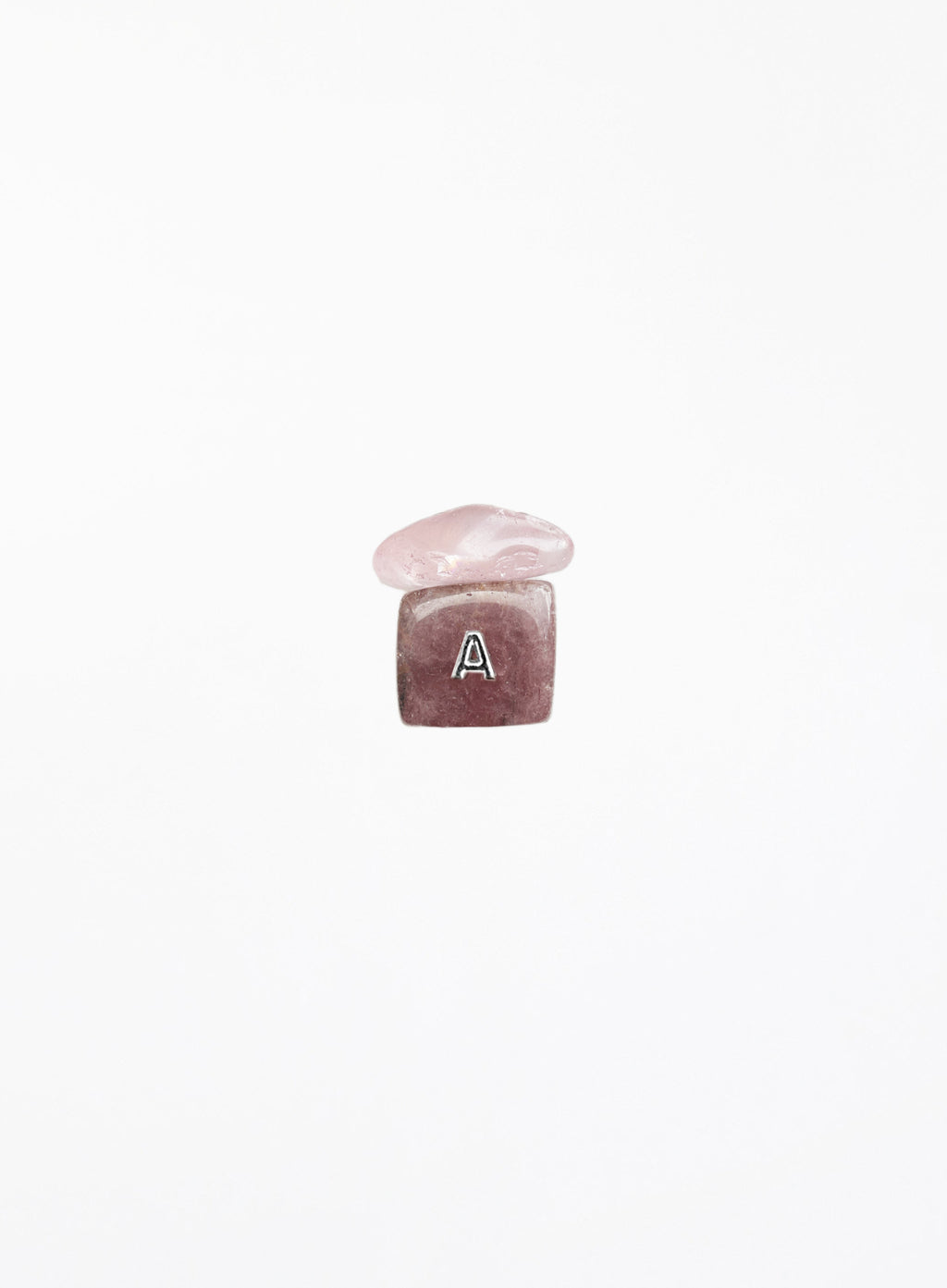 A small pink gemstone charm with a polished rounded top and a faceted square base engraved with the letter 'A', centered on a plain white background.