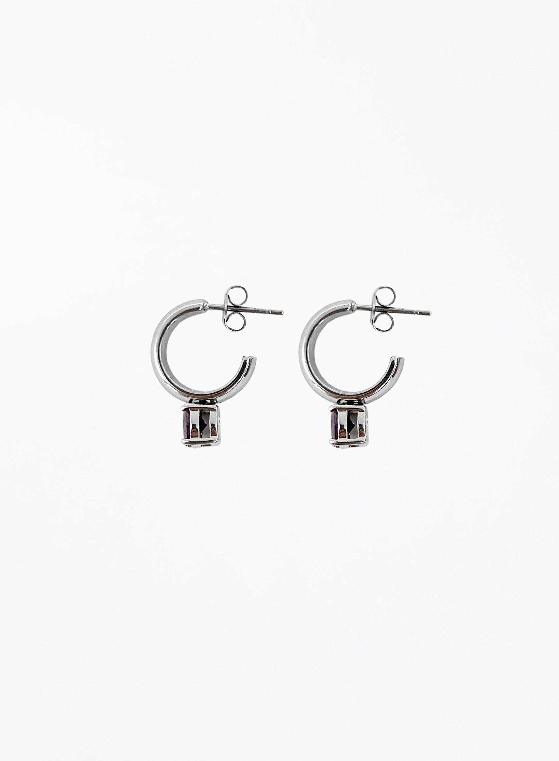 Pair of silver hoop earrings on a white background