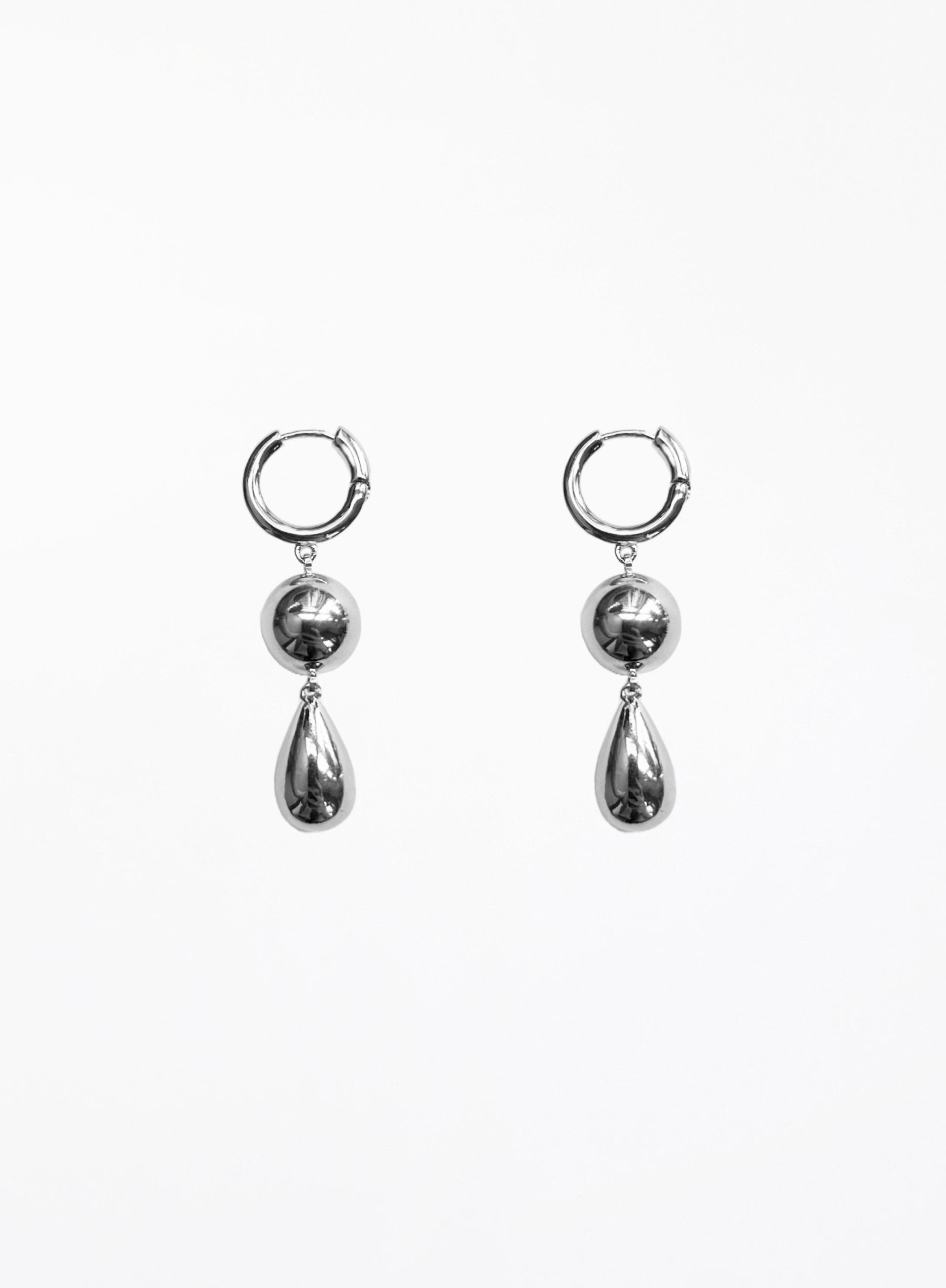 Pair of silver hoop earrings with teardrop-shaped charms on a white background