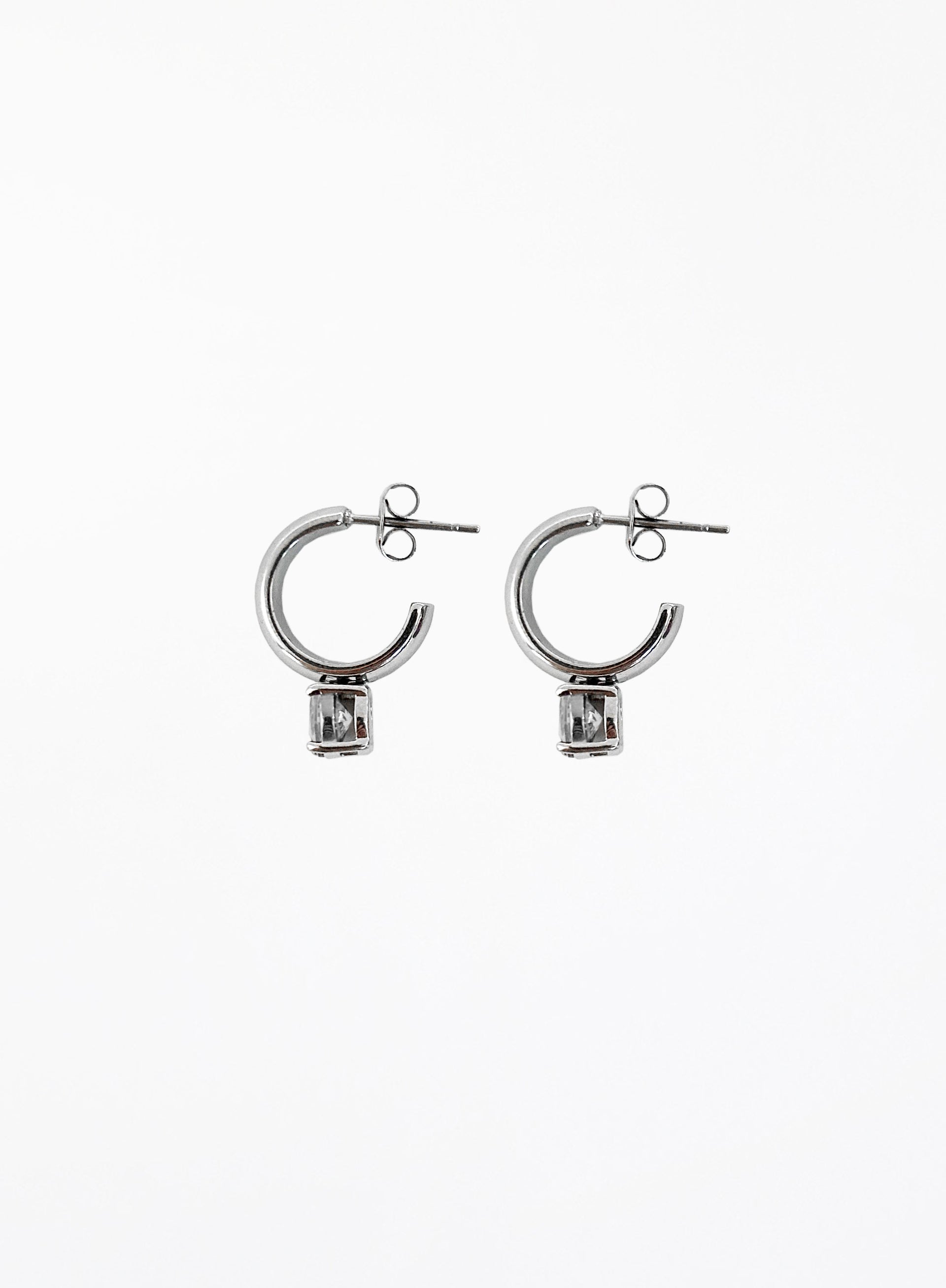 Pair of silver hoop earrings on a white background
