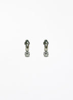 Pair of silver hoop earrings with small round gemstones on a white background