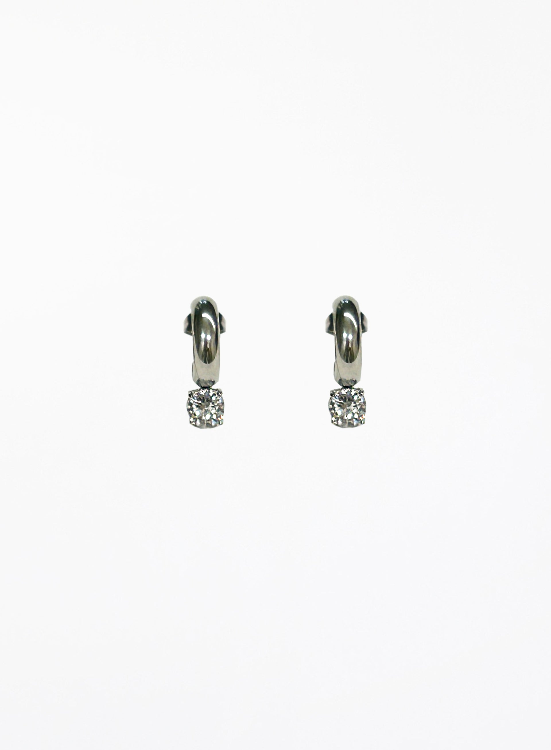 Pair of silver hoop earrings with small round gemstones on a white background