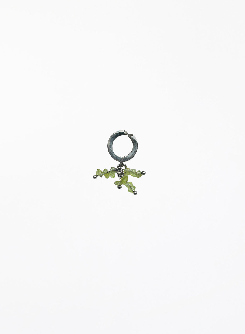 green peridot earcuff on white background
