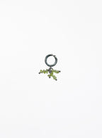 green peridot earcuff on white background