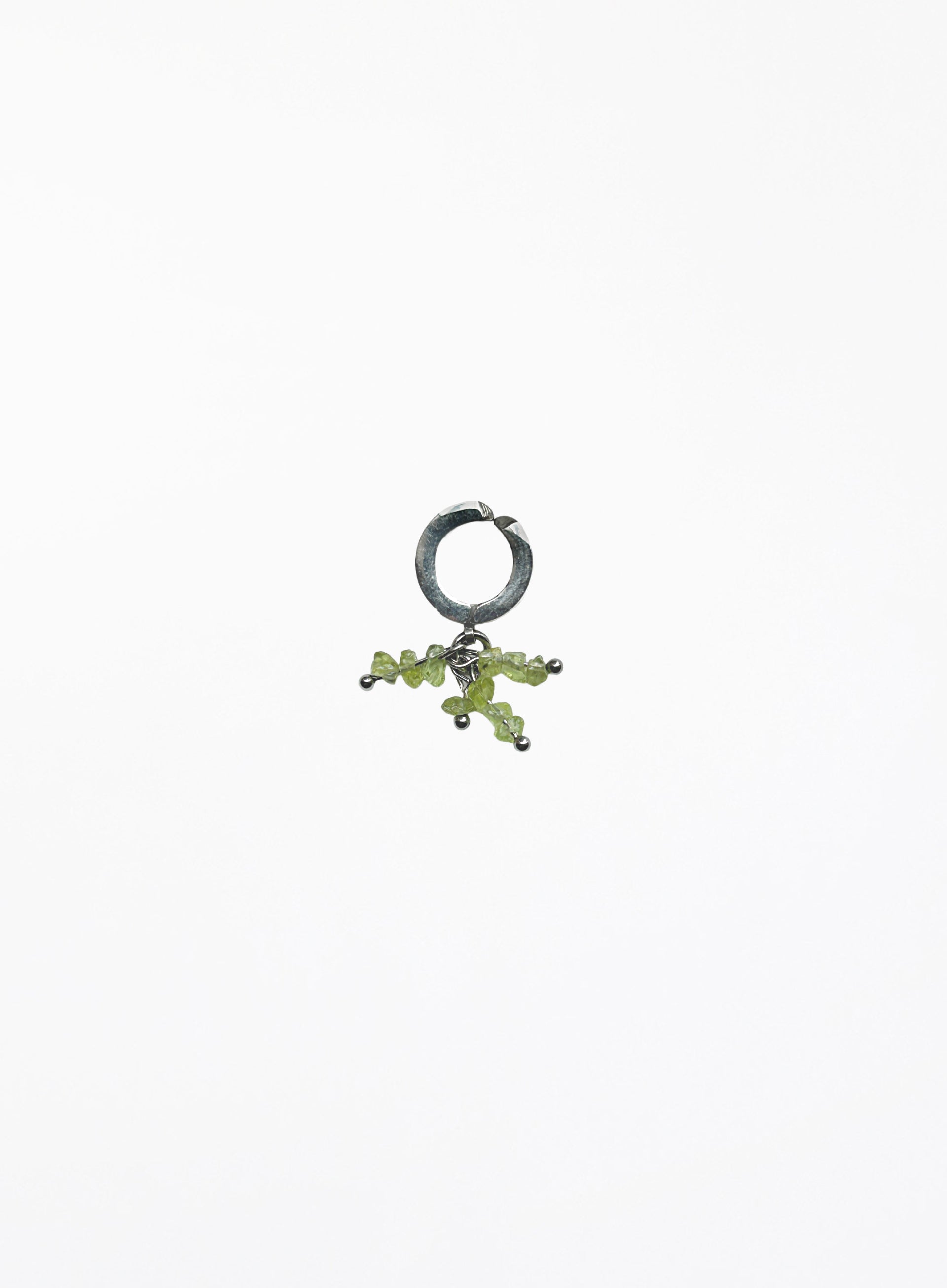 green peridot earcuff on white background