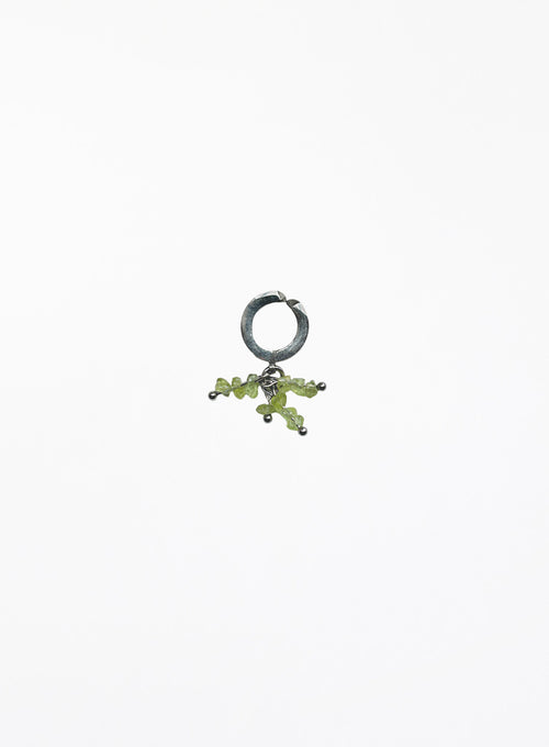 green peridot earcuff on white background