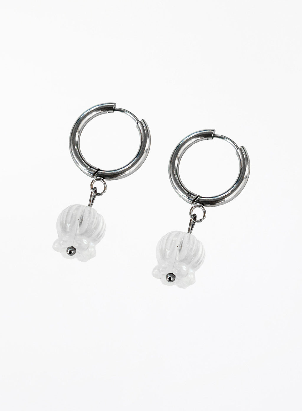 Silver hoop earrings with white stone charms on a white background
