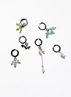 Set of five earcuffs with various designs on a white background