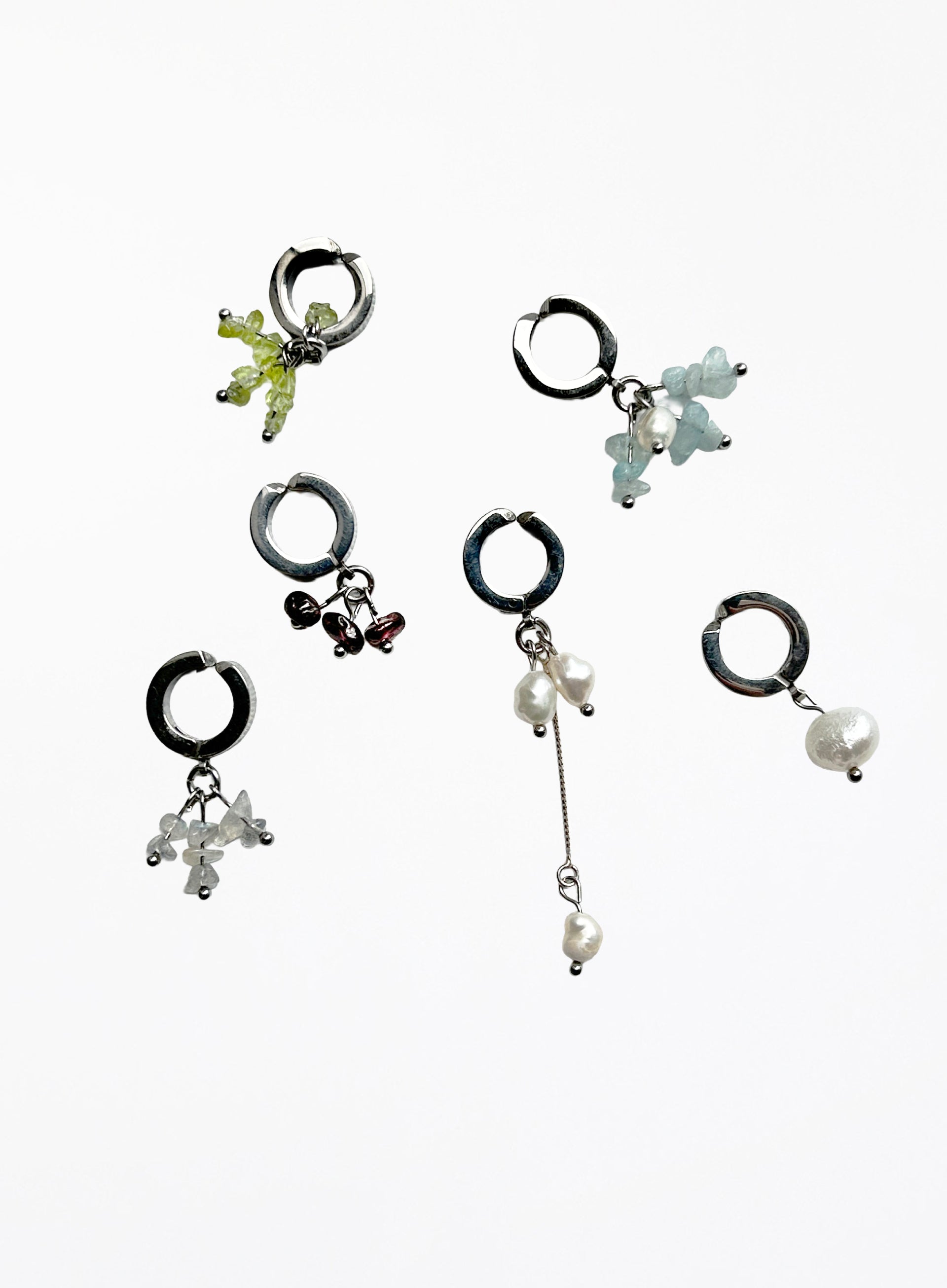 Set of five earcuffs with various designs on a white background