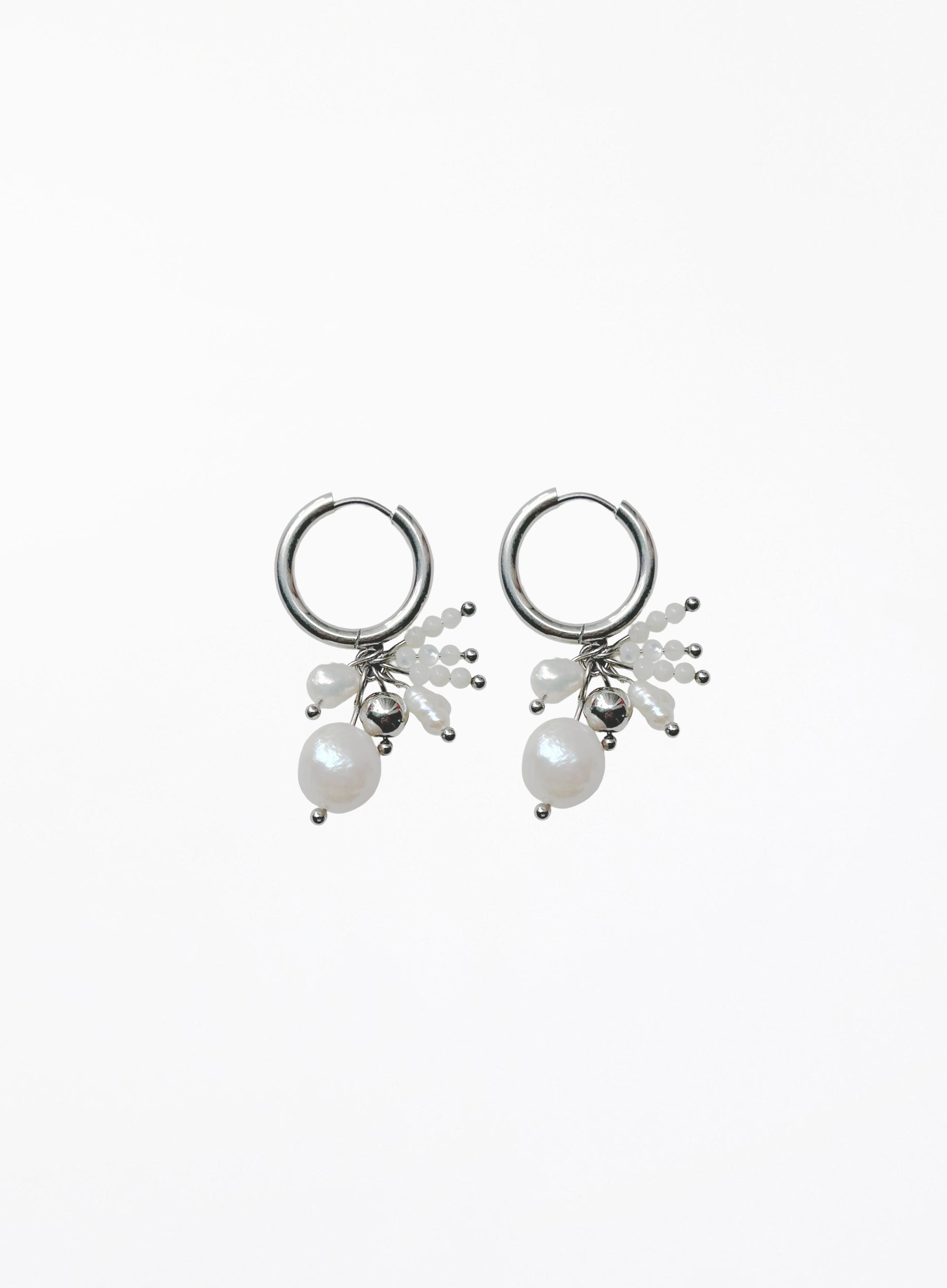 A pair of silver hoop earrings with dangling pearl clusters and small silver beads, shown on a plain white background.
