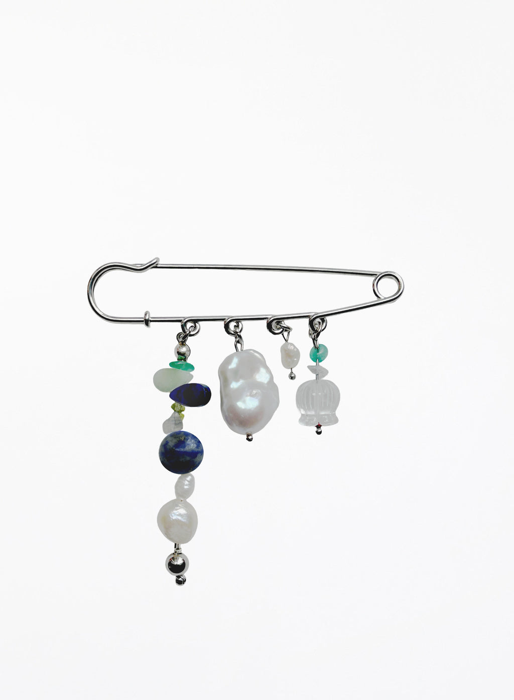A silver safety pin styled as a hair claw clip, adorned with various beaded strands including white pearls, a dark blue bead, and small green and white stones, set against a plain white background.