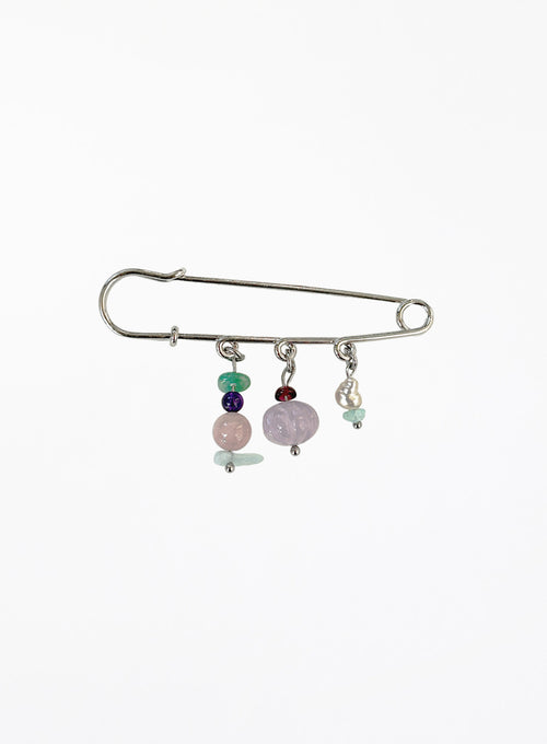 Silver brooch with colorful beads on a white background