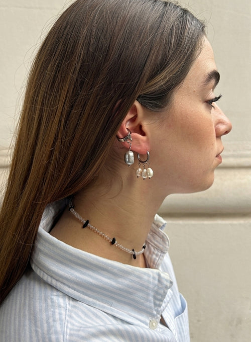 a woman wearing pearl earrings