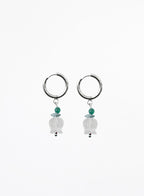 Pair of hoop earrings with hanging beads on a white background