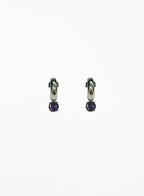 Pair of silver hoop earrings with purple gemstones on a white background