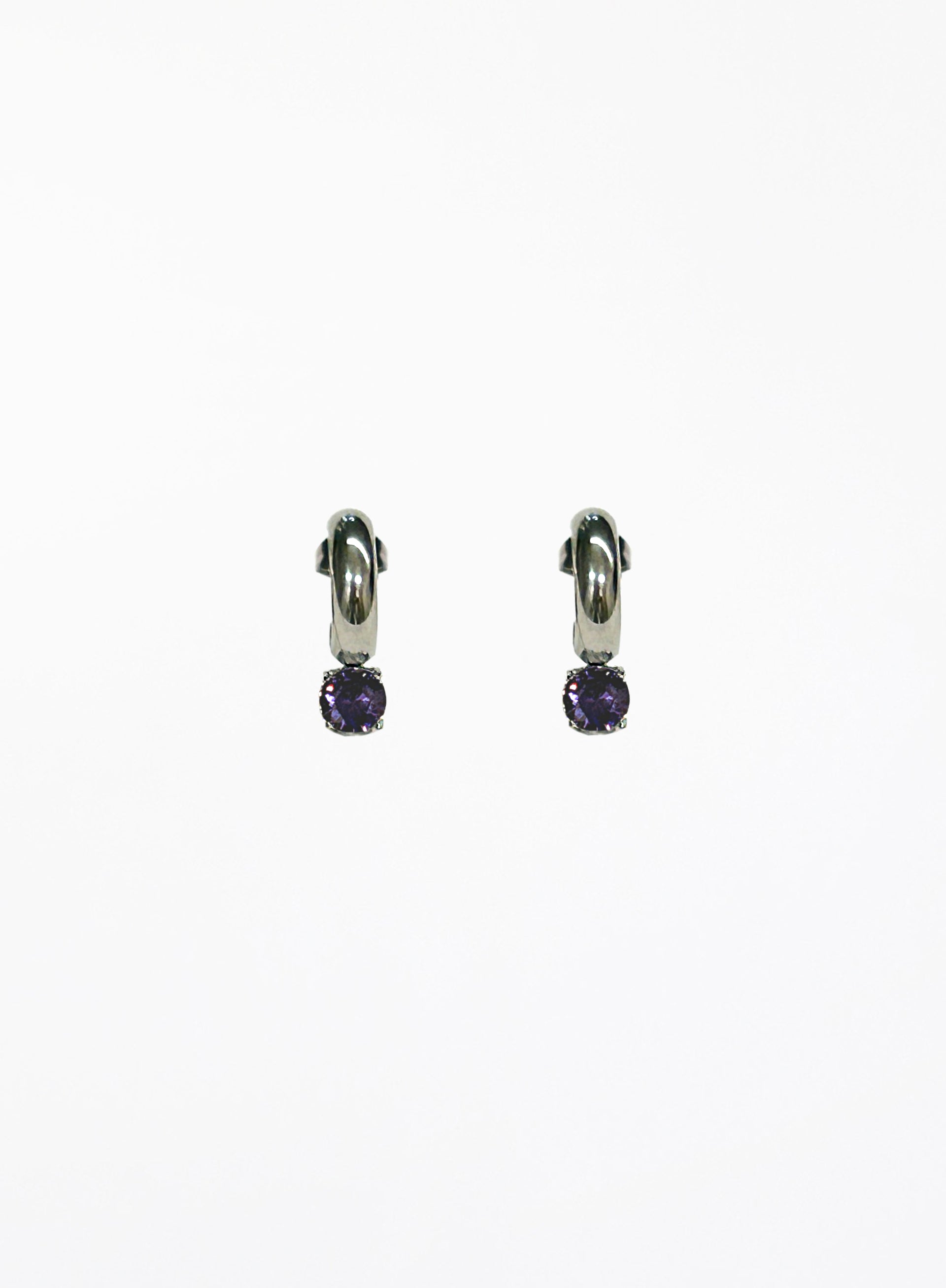 Pair of silver hoop earrings with purple gemstones on a white background