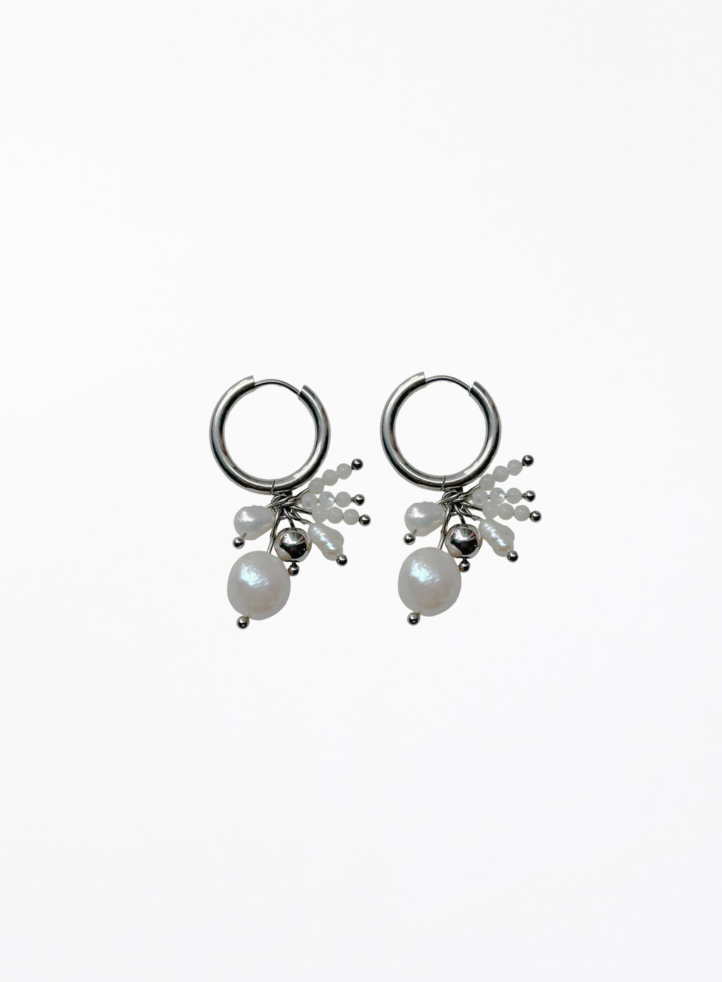 Pair of silver hoop earrings with pearl drops on a white background