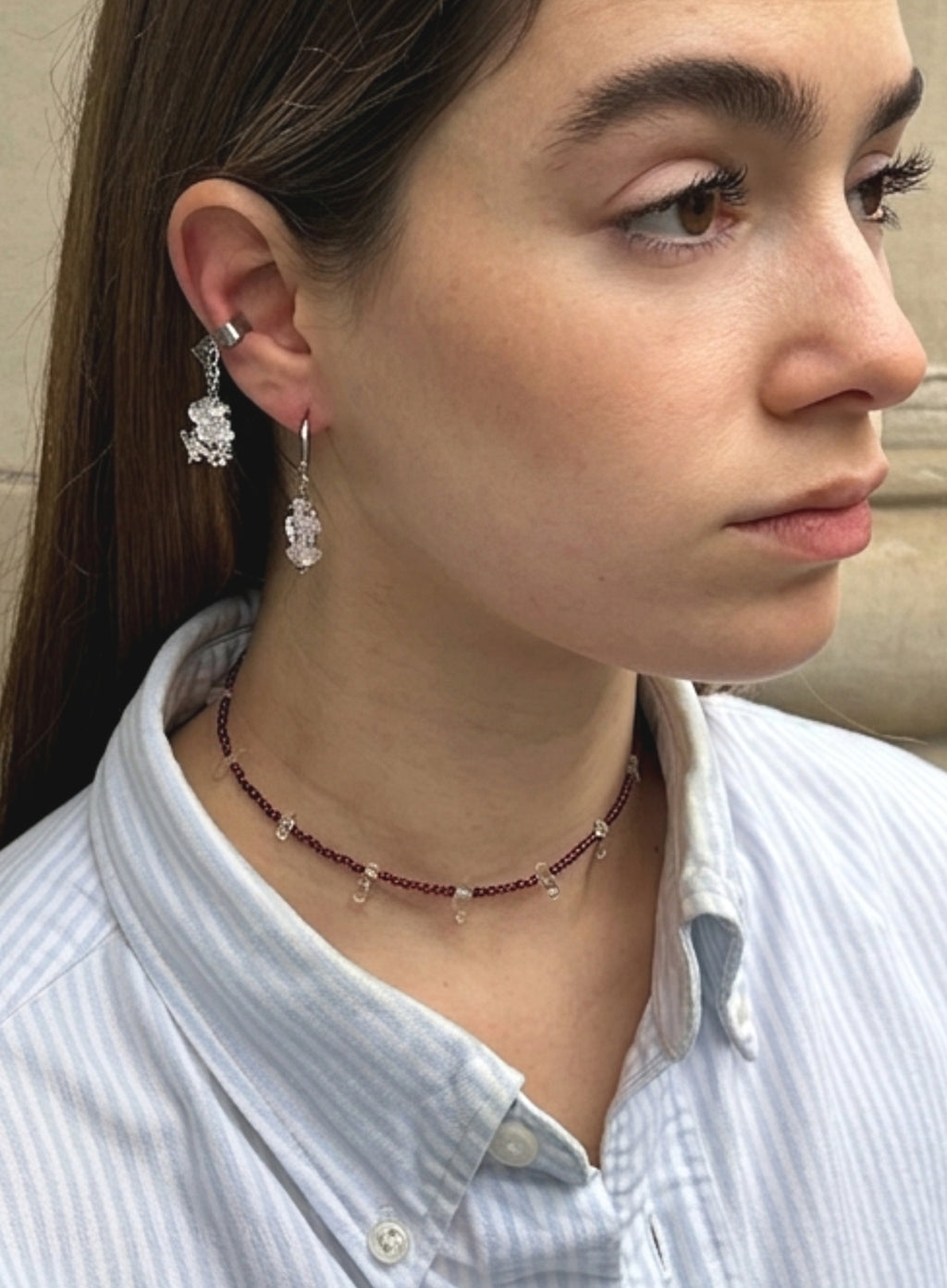 woman wearing garnet collar necklace and earrings
