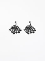 Pair of silver beaded hoop earrings on a white background