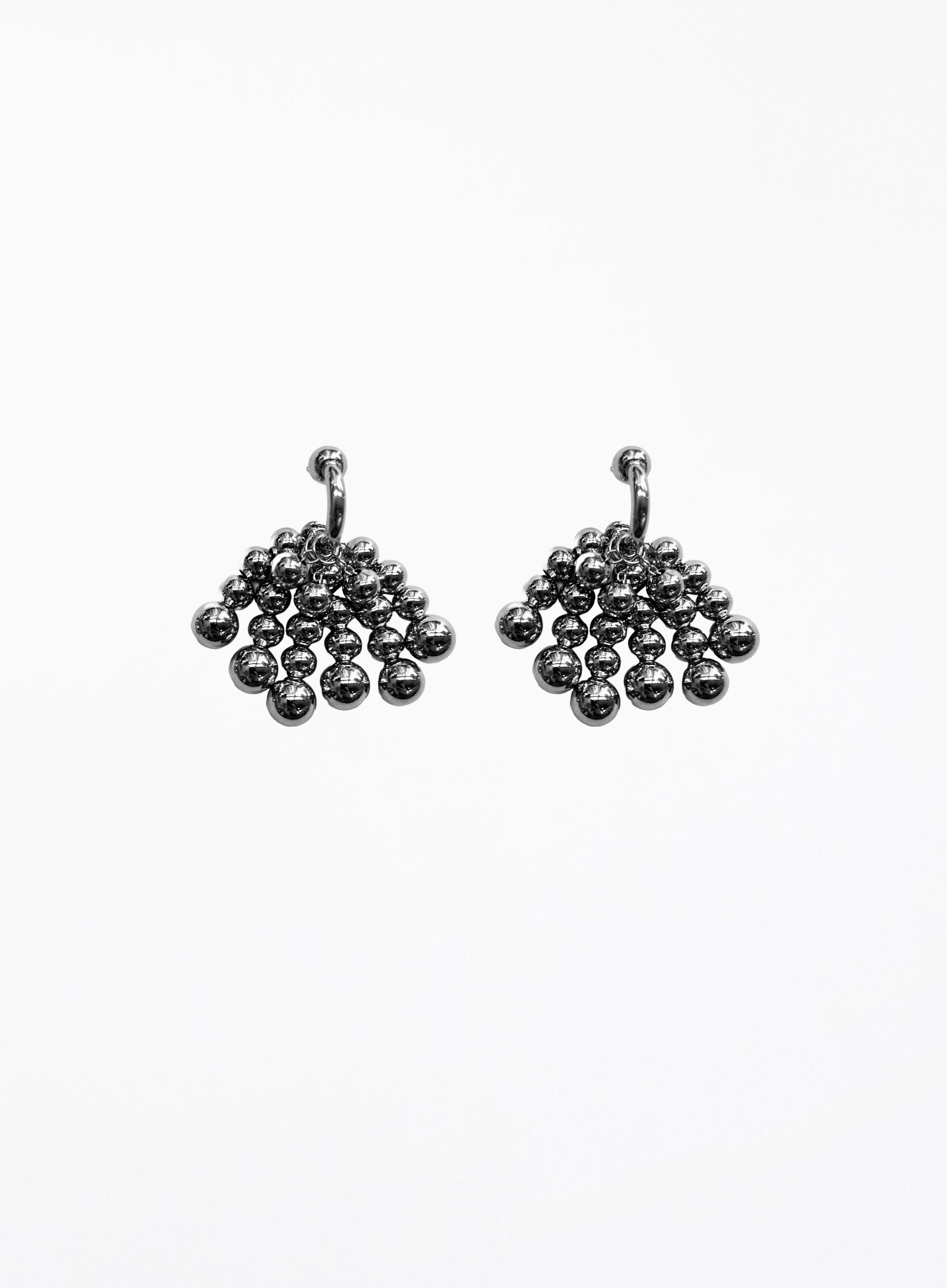 Pair of silver beaded hoop earrings on a white background