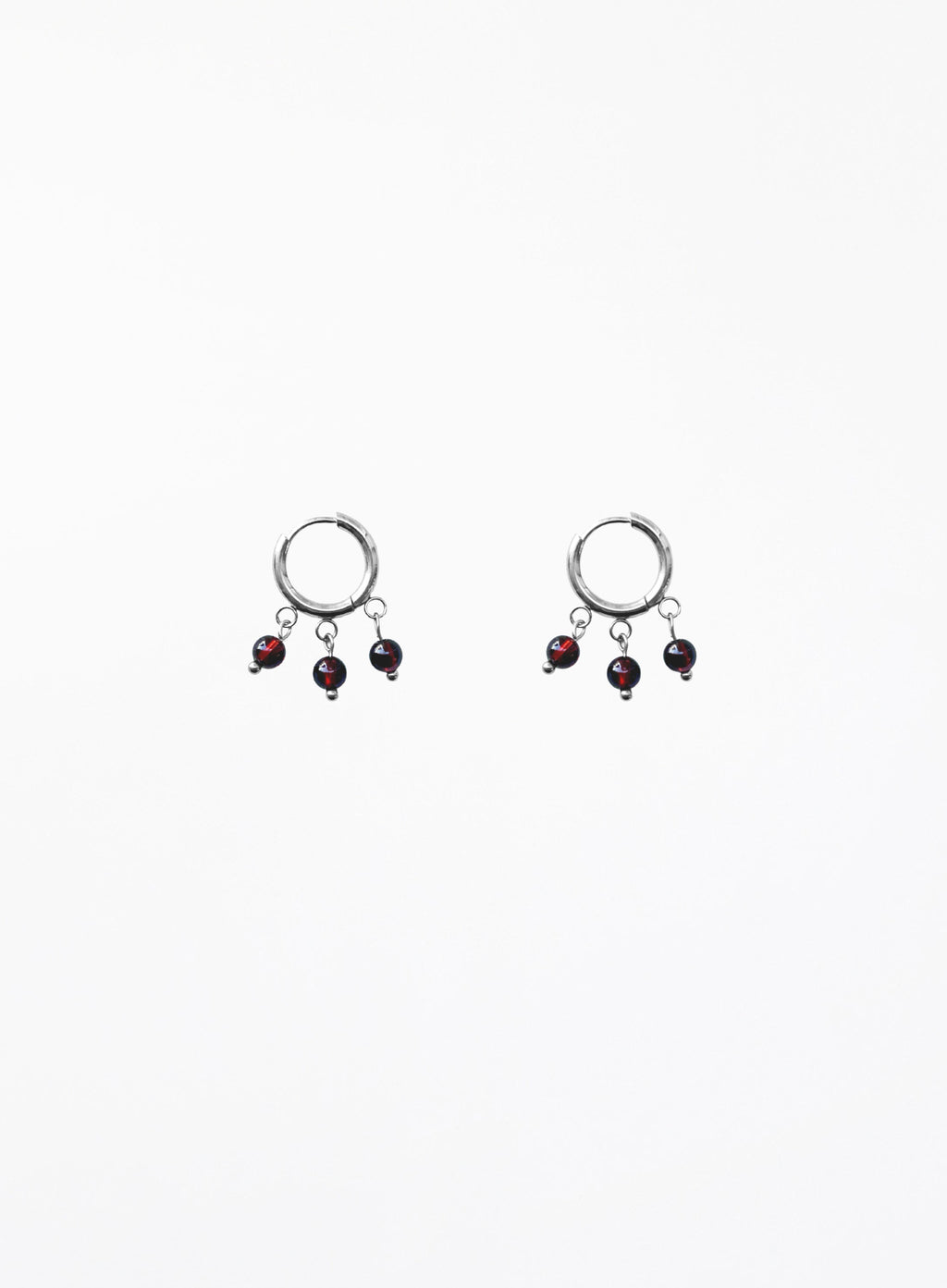 Pair of earrings with dangling beads on a white background