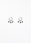 Pair of earrings with dangling beads on a white background