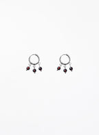 Pair of earrings with dangling beads on a white background