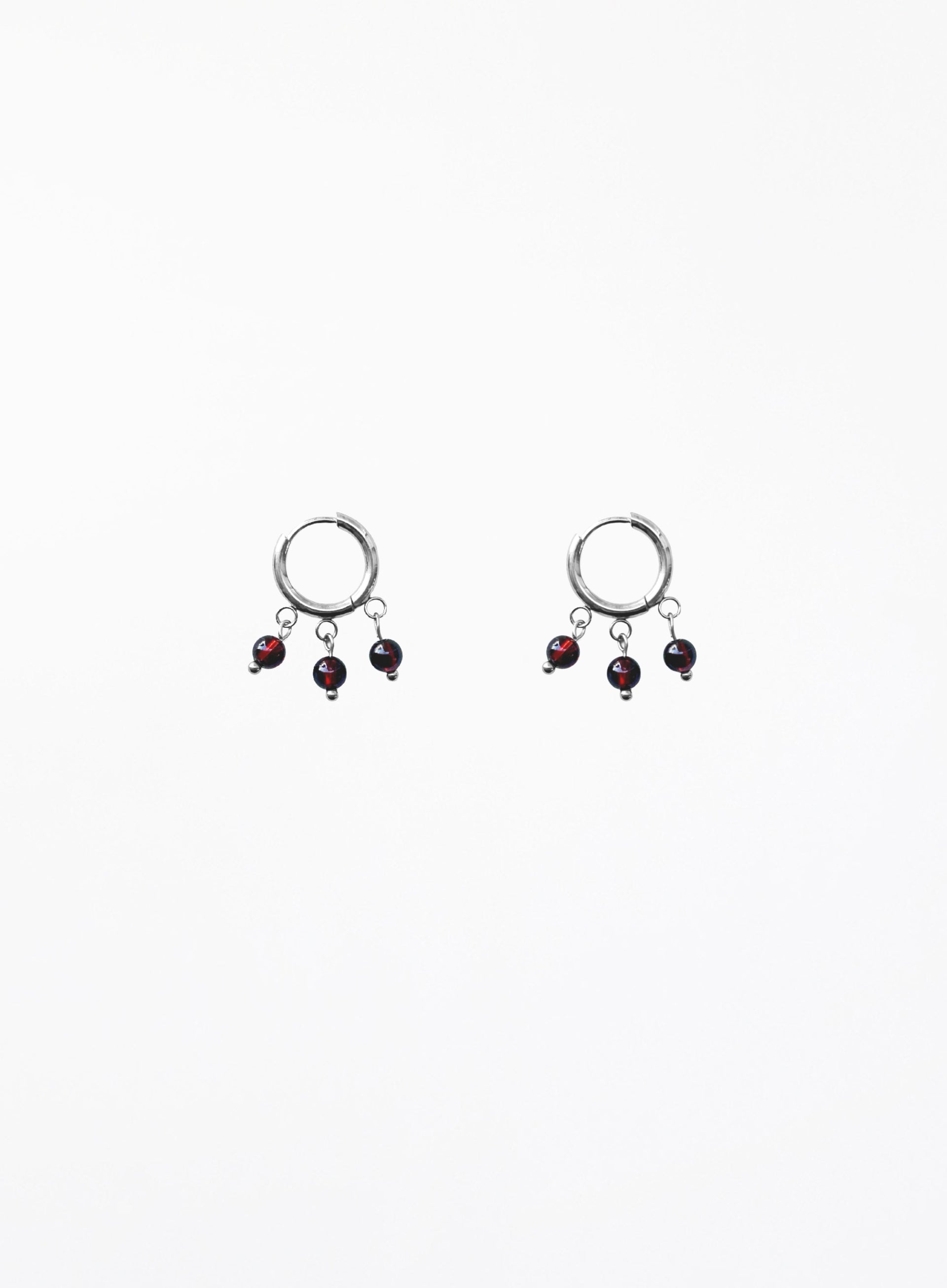 Pair of earrings with dangling beads on a white background