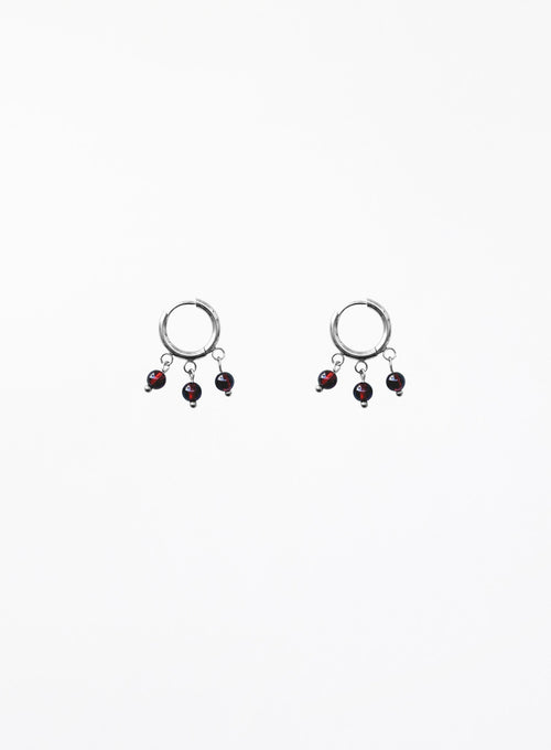 Pair of earrings with dangling beads on a white background