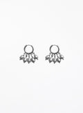 a pearl of grey pearl charms earrings in huggie hoop against white background