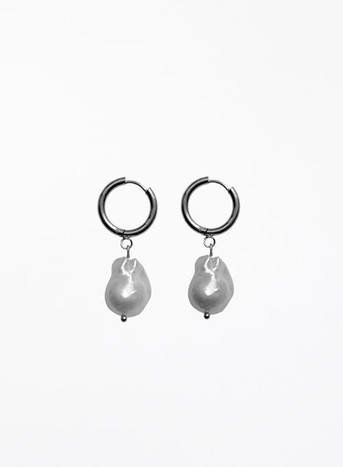 Pair of hoop earrings with baroque pearl drops on a white background