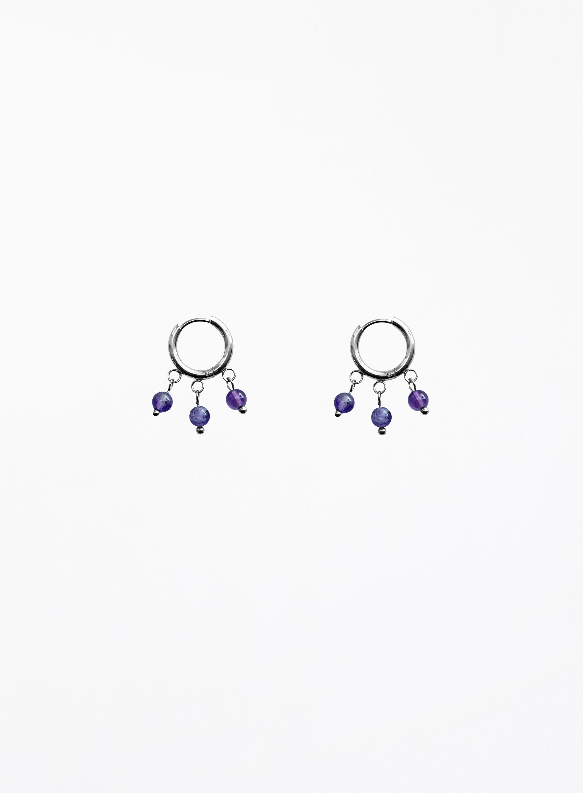 Pair of hoop earrings with purple beads on a white background