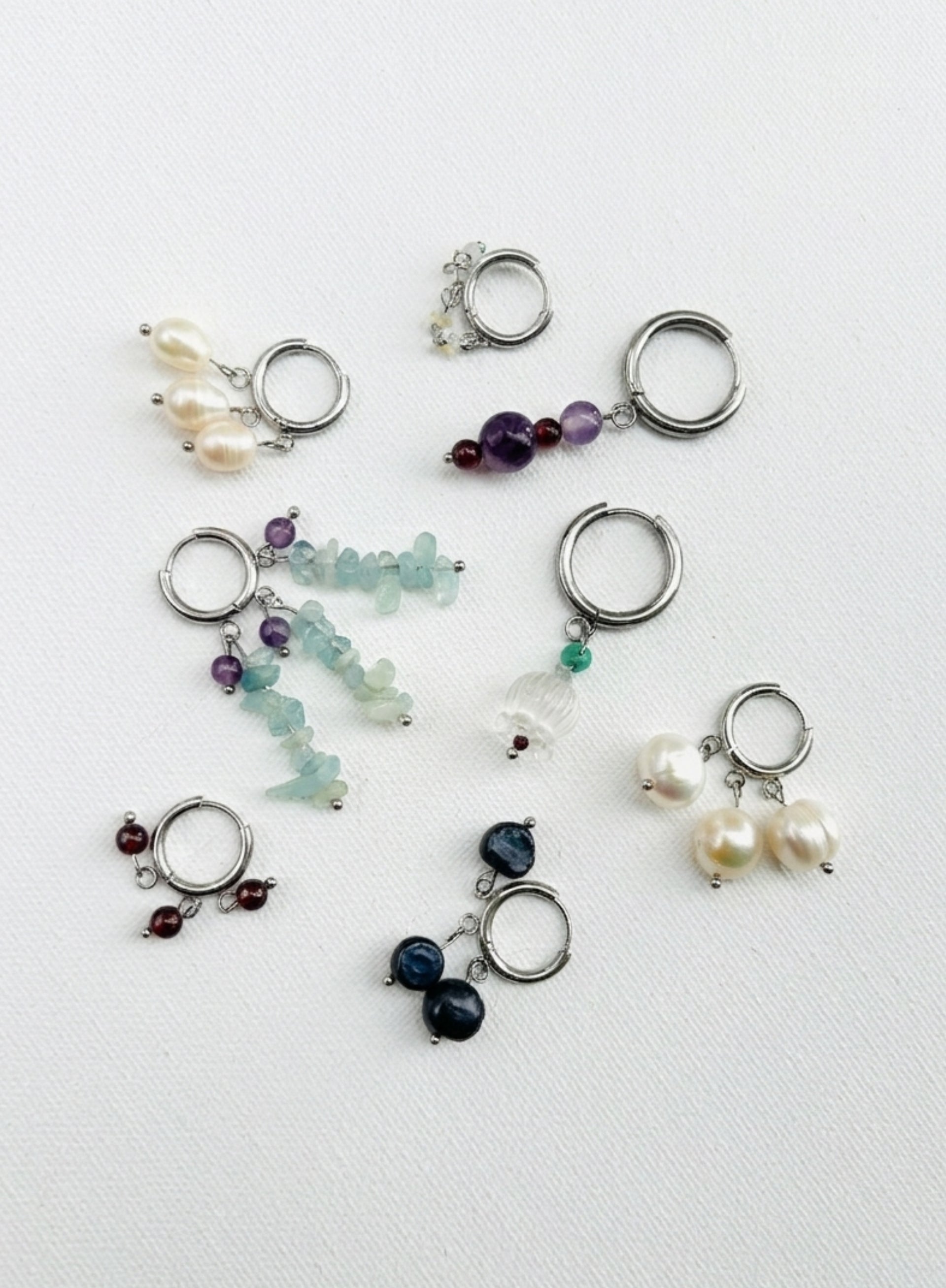 Collection of various gemstone keychains on a white background