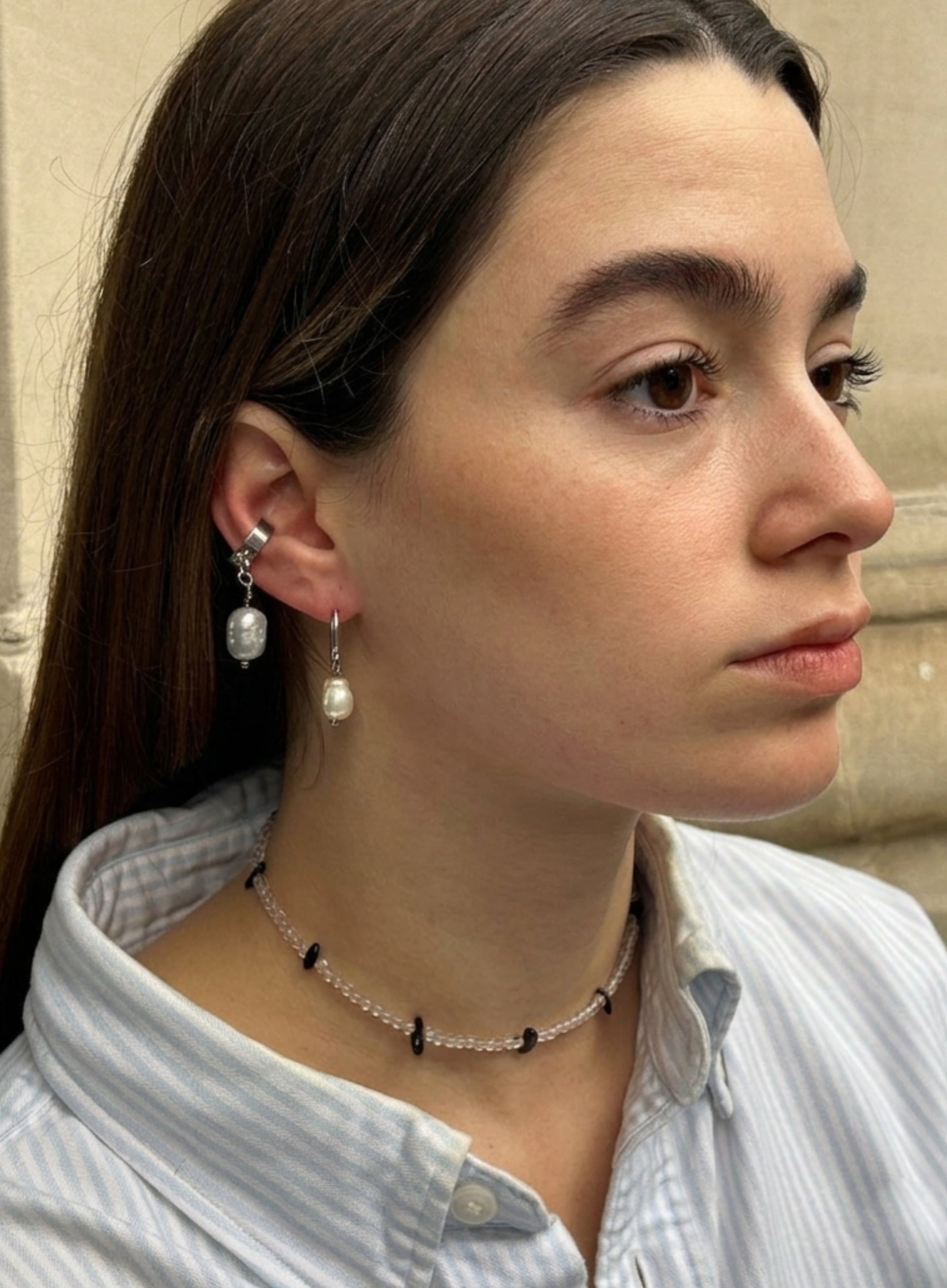 a woman wearing pearl earrings