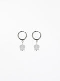 Pair of silver hoop earrings with white bulb-shaped charms on a white background