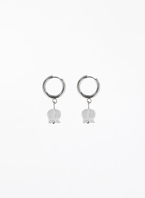 Pair of silver hoop earrings with white bulb-shaped charms on a white background