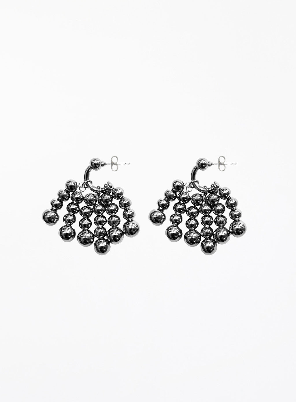 Pair of silver beaded hoop earrings on a white background